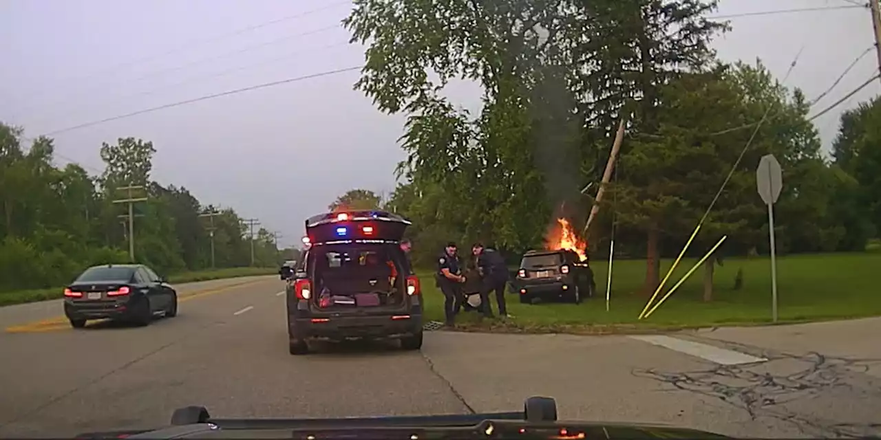 Police officers rescue unconscious driver from burning vehicle on Mayfield Road (video)