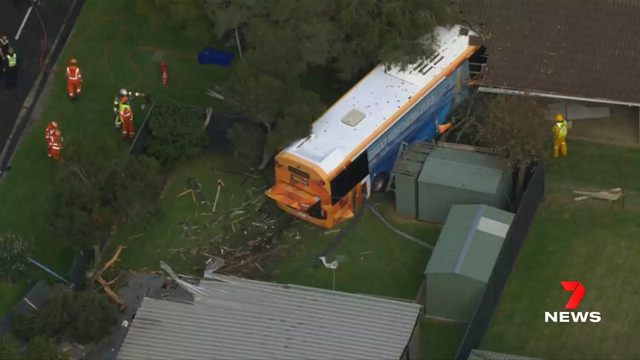 Bus smashes into houses after crashing through fence