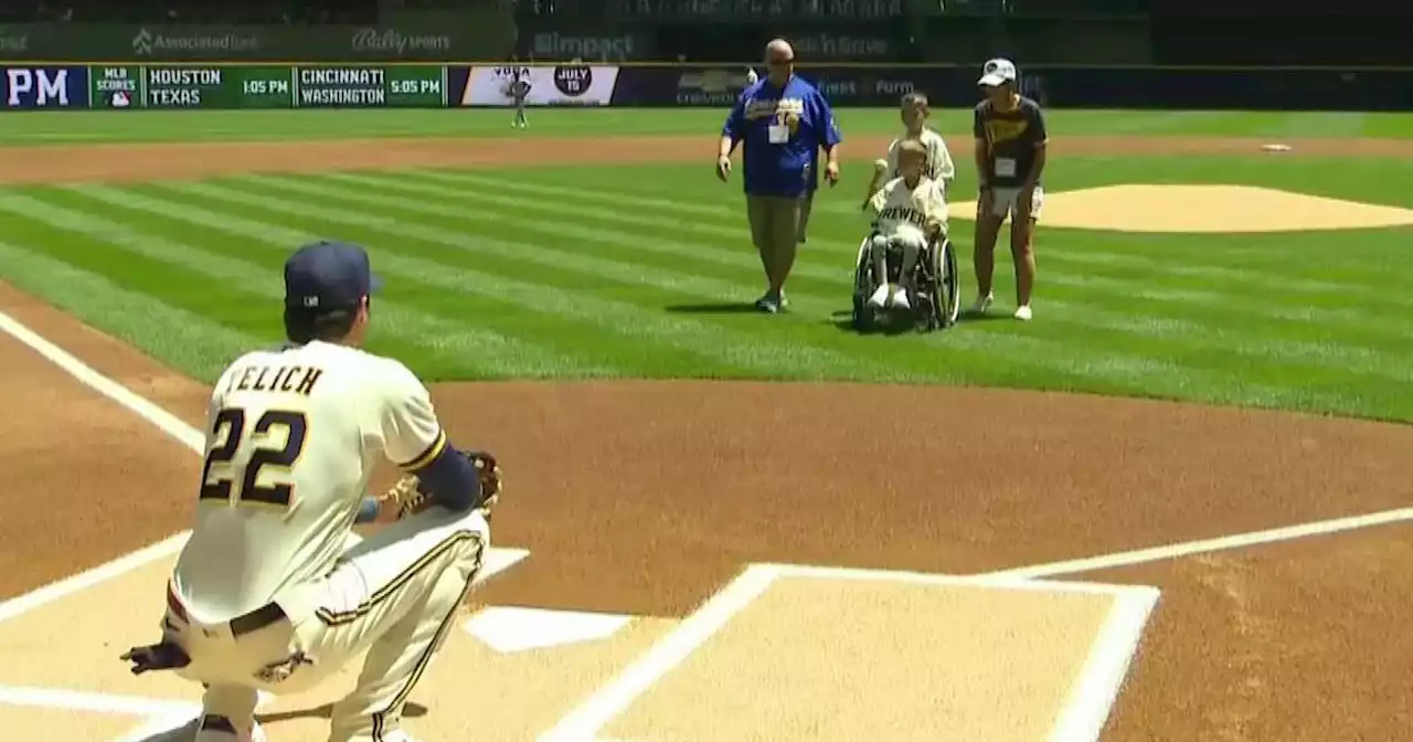 Boy injured in parade shooting throws out first pitch