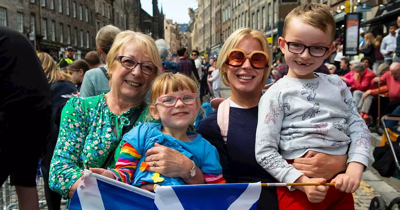 Royal spectators cheer and wave at King and Queen during procession