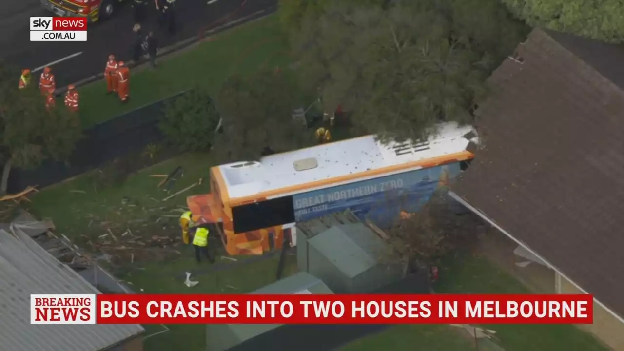 Two people injured after bus crashes into two houses