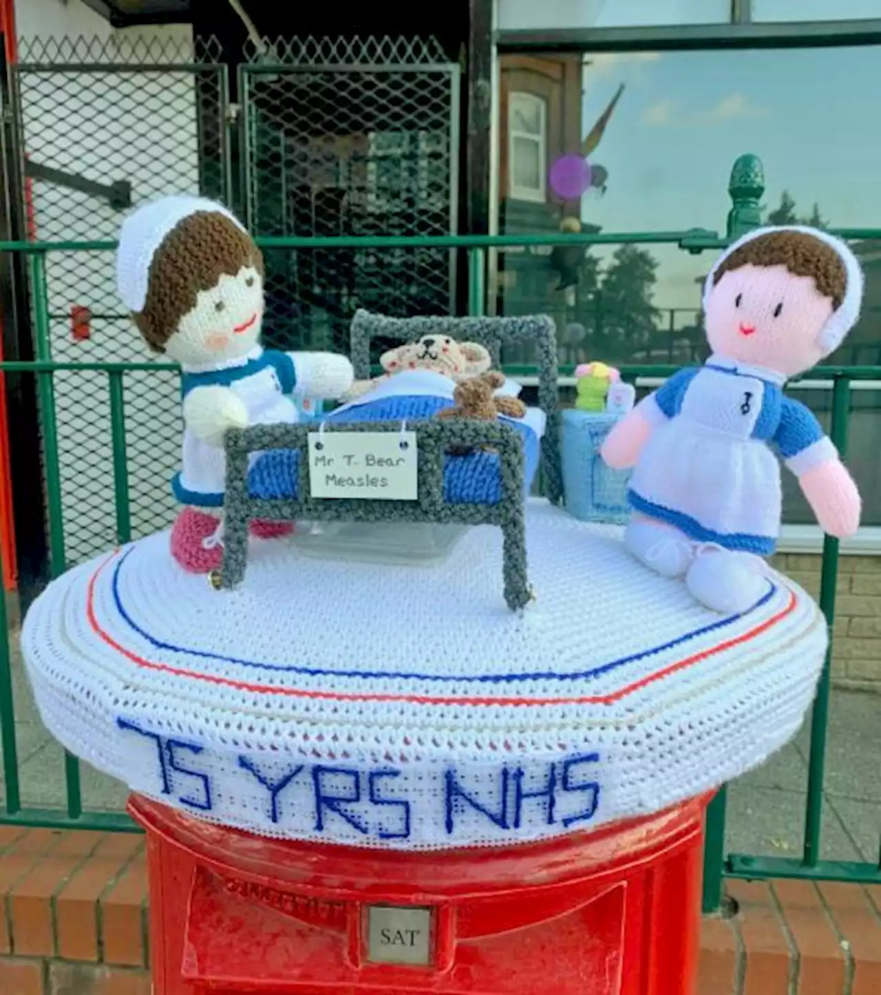 Knitting group create postbox topper and 75 baby hats for NHS 75th anniversary