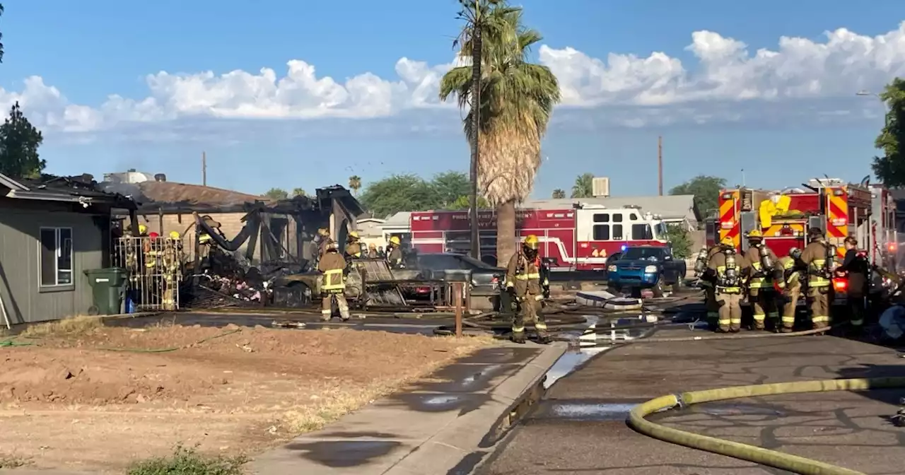 Firefighter hospitalized, 12 displaced after double house fire near 67th Avenue and Thomas Road