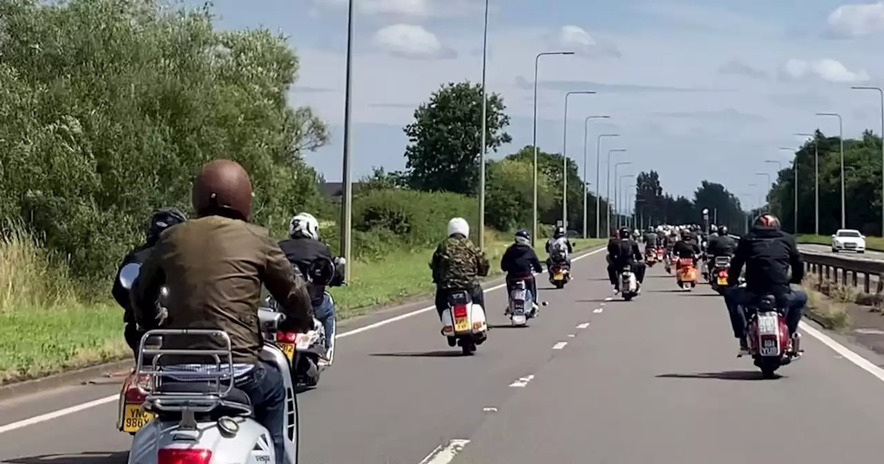 Moment hundreds of scooters take over East Lancs Road in procession