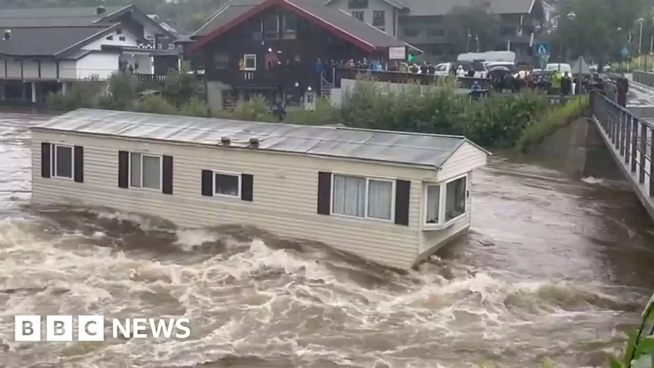 Watch: Floodwaters send mobile home crashing into bridge