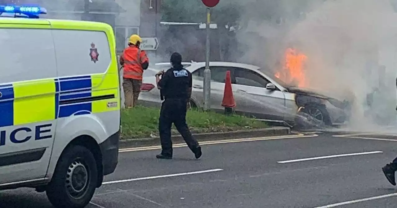 Road closed as fire crews tackle huge car blaze near Stretford - live updates