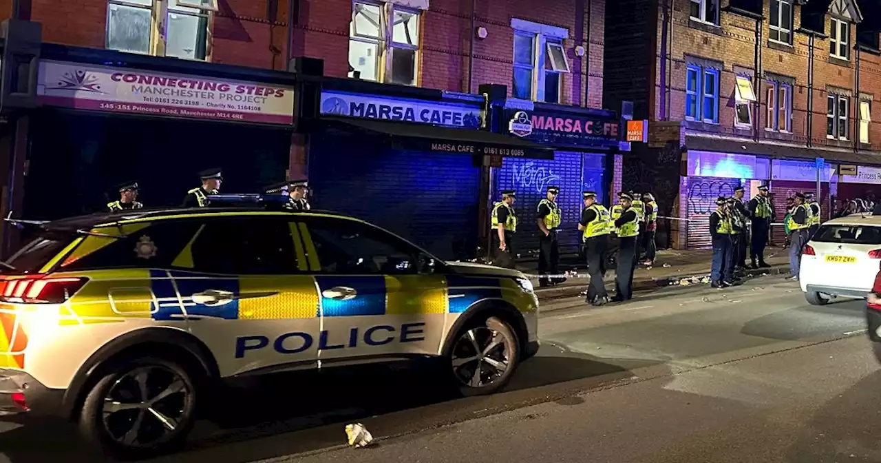 Police swarm street after 'disturbance' in Moss Side with two men hospitalised