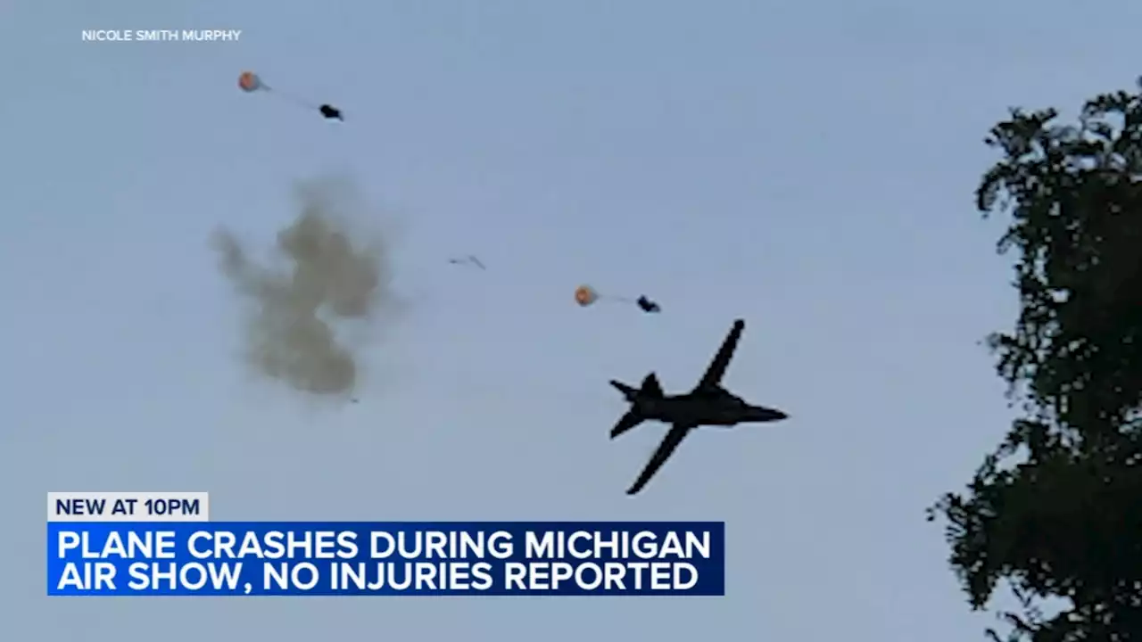 Caught on camera: 2 people parachute out of crashing plane at Michigan air show