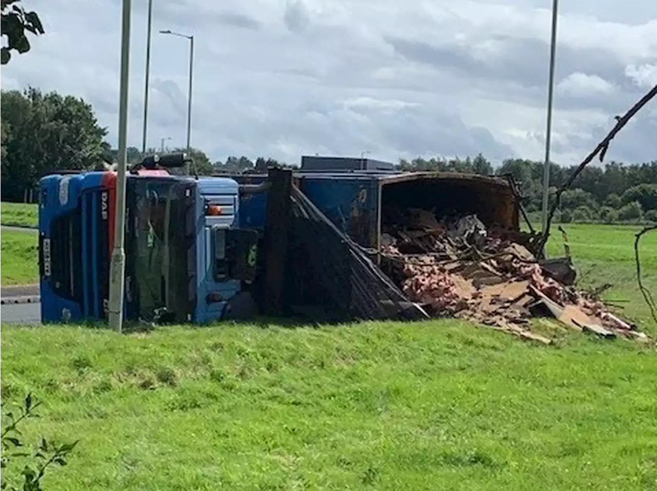 Man helped by firefighters and ambulance after truck tips over and sheds load in Telford