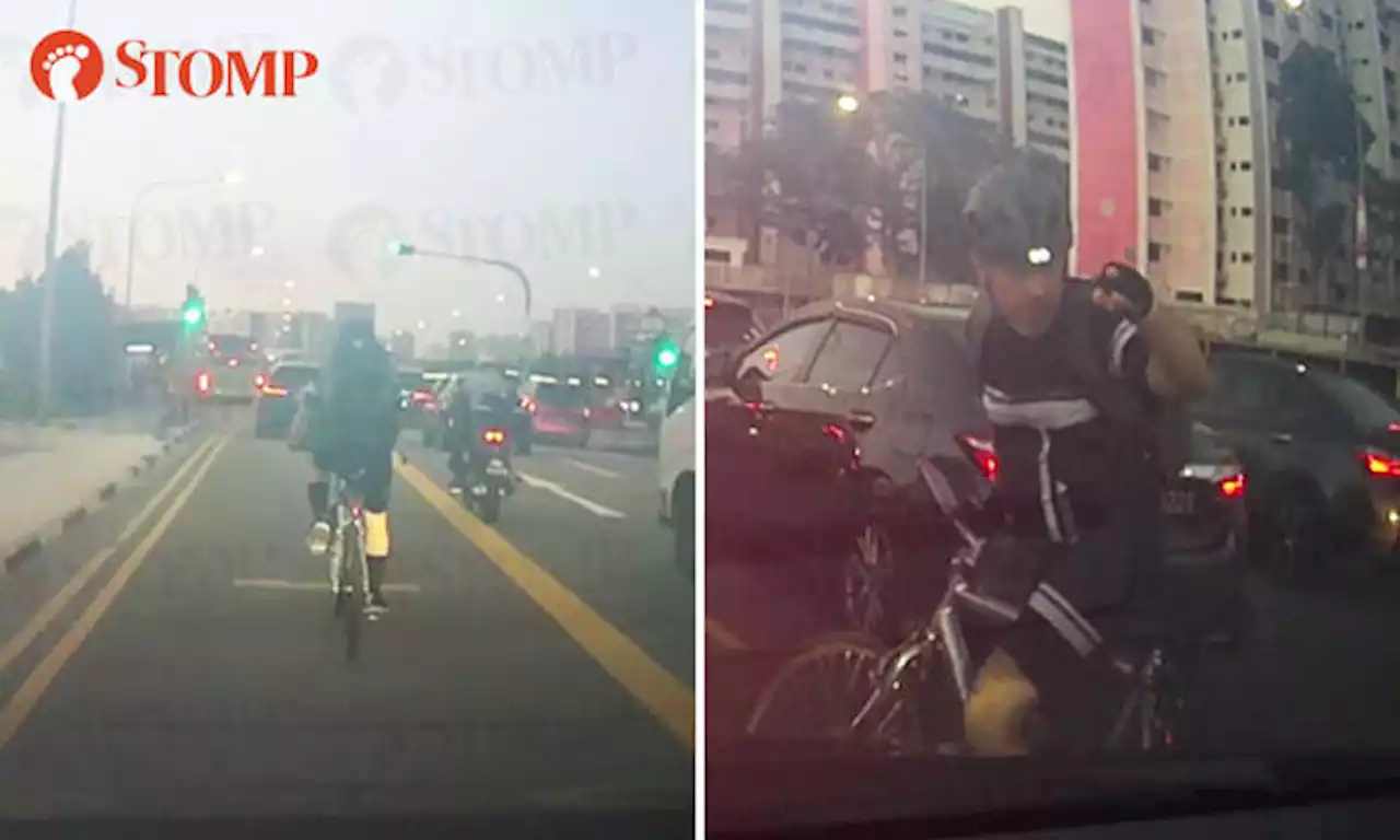 Cyclist gestures at driver after she uses high beam, honks at him for hogging lane