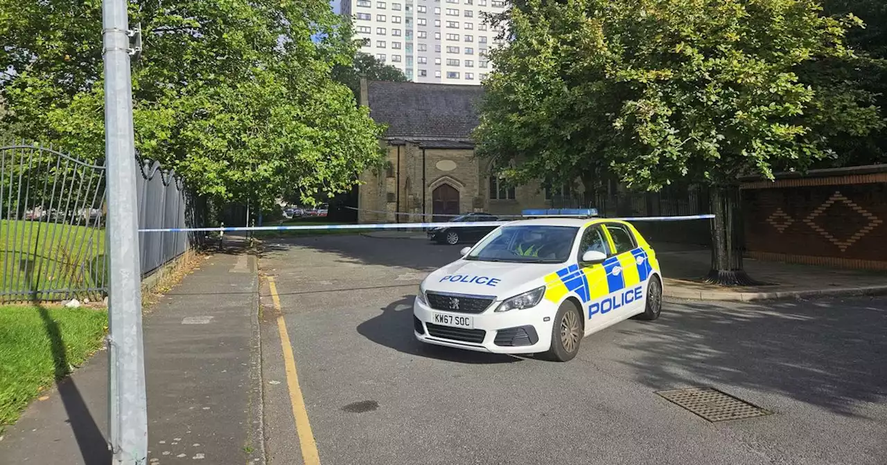 Officers tape off area outside apartment block following 'suspected shooting'