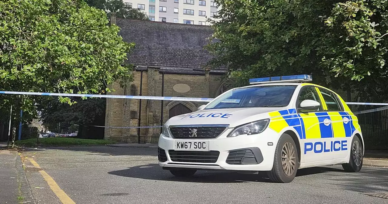 Police descend on Greater Manchester road with area taped off