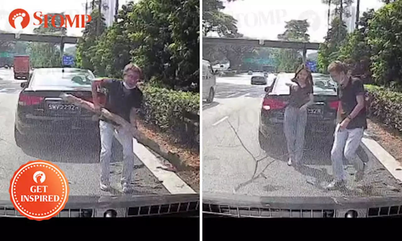 Cabby gets out of taxi to clear road of fallen branches -- and even gets help from passenger