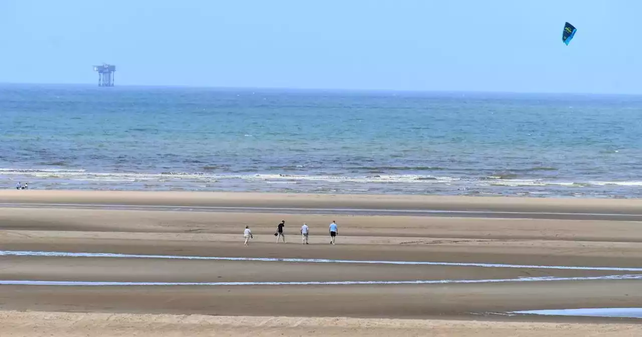 Man dies after falling ill on Merseyside beach