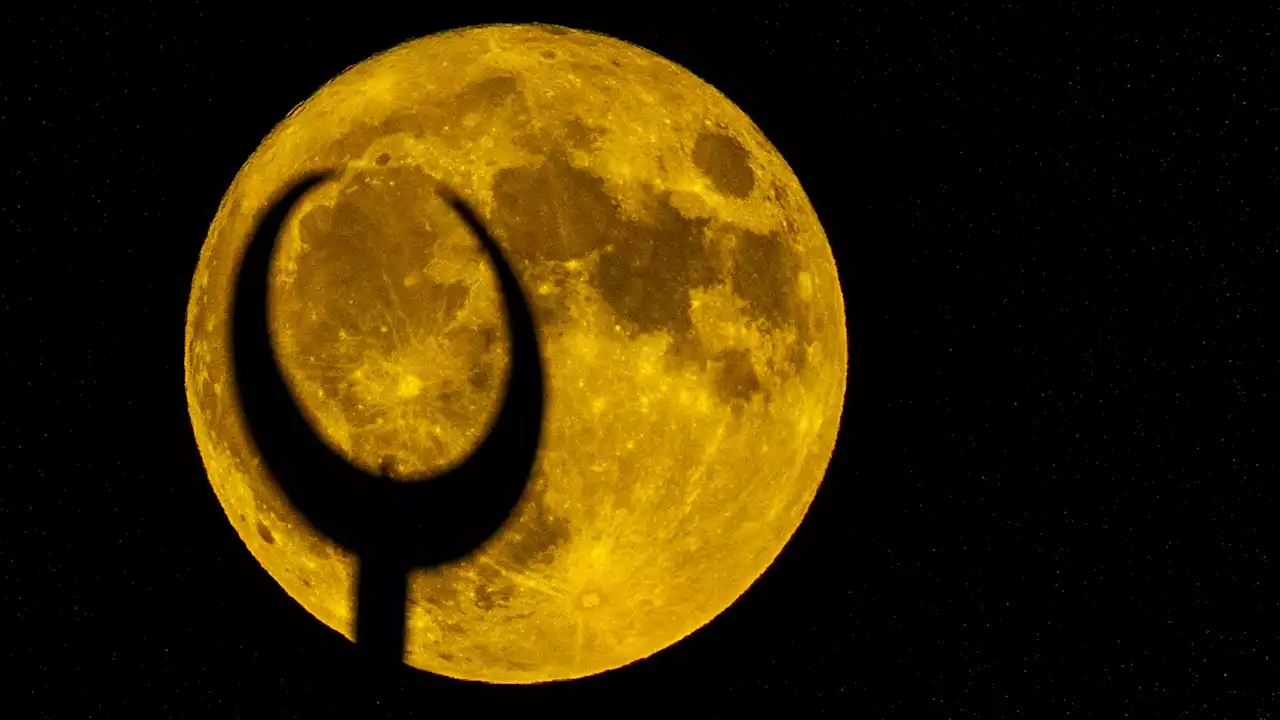 AP PHOTOS: The first supermoon in August rises around the world