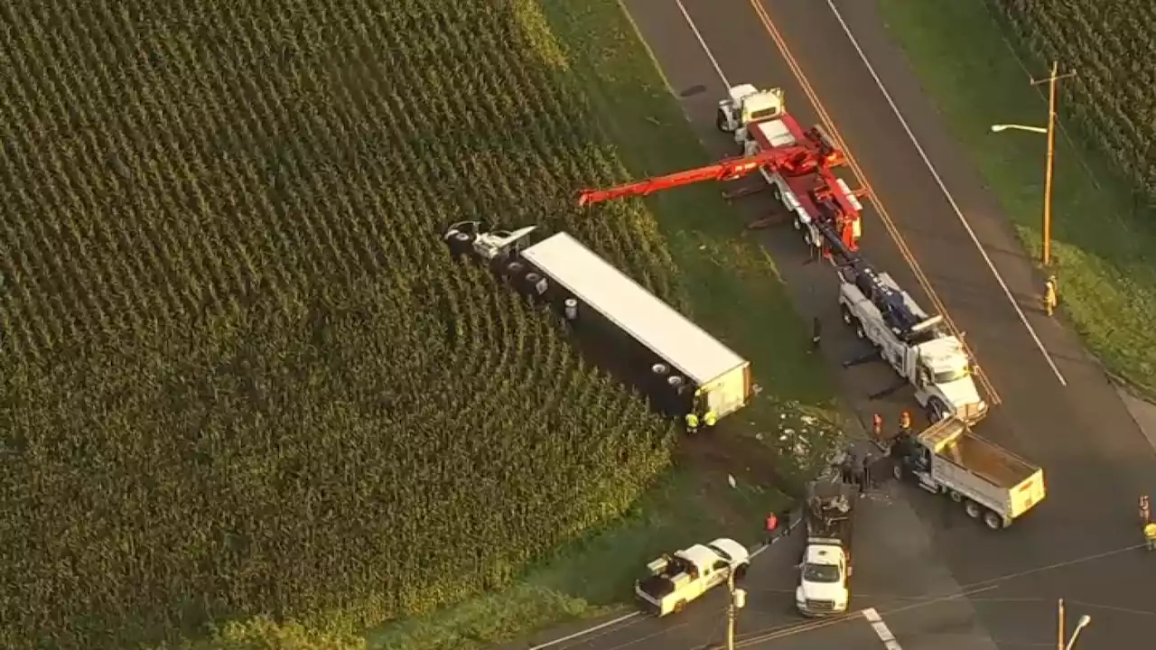 Truck overturns in field after crashing off NJ road