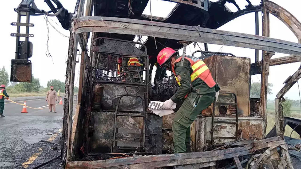 Pakistan bus crash kills at least 18 as vehicle bursts into flames on motorway hard shoulder