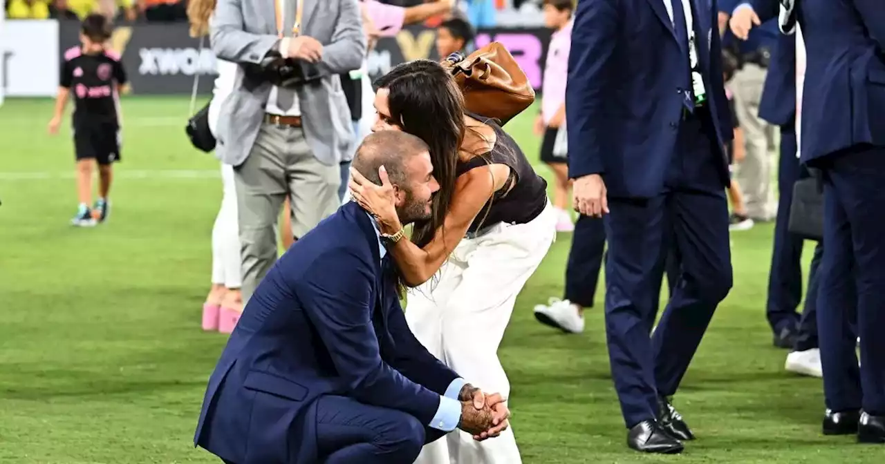 Victoria Beckham rushes onto pitch to give husband David a huge hug after final