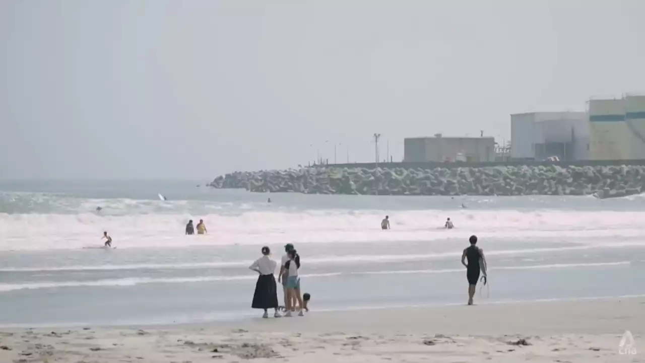 Japanese surfers aiming to bring tourists back to Fukushima town brave waves near nuclear plant