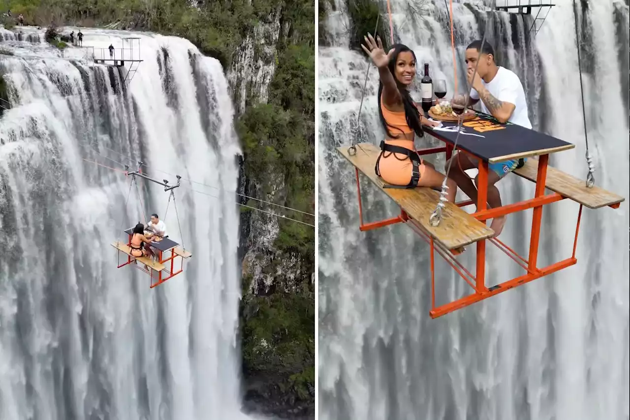 Daredevil couple dines at table hanging 295 feet in air above rapid waterfall: jaw-dropping video