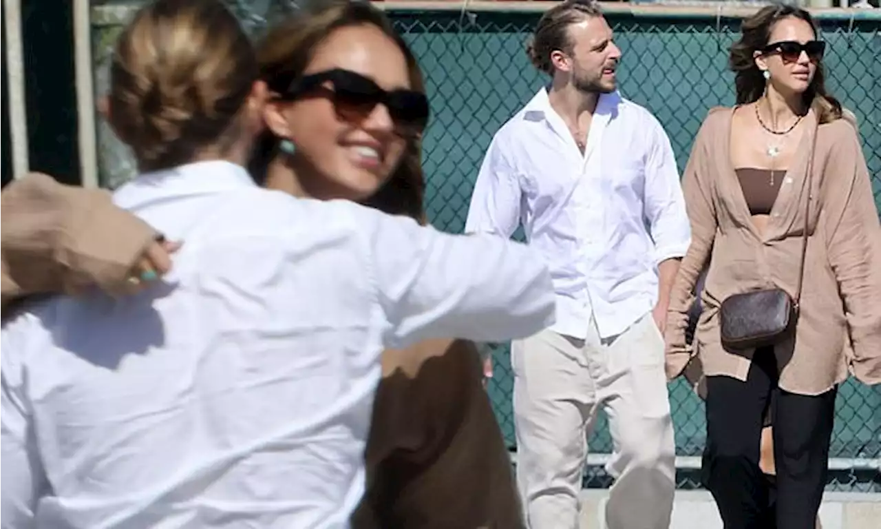 Jessica Alba receives a hug from Brandon Green at a tennis match in LA