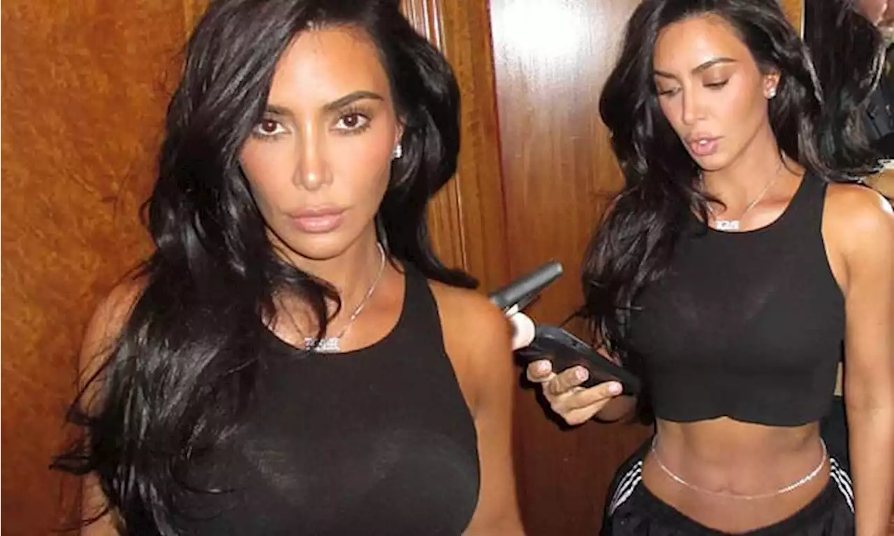 Kim Kardashian shows off her toned abs in crop top and low-rise pants