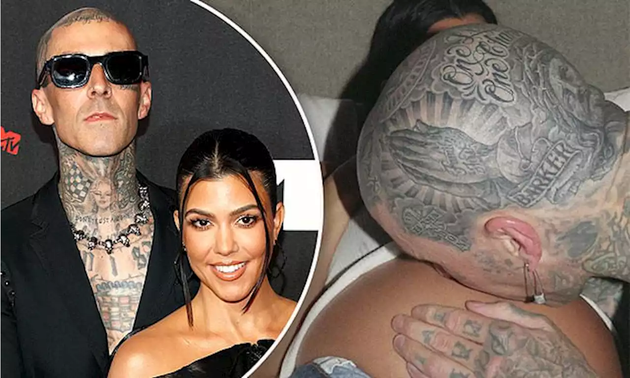 Travis Barker gives Kourtney Kardashian and her baby bump a kiss