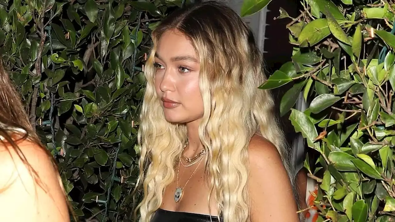 Gigi Hadid flashes her midriff in black leather crop top and jeans