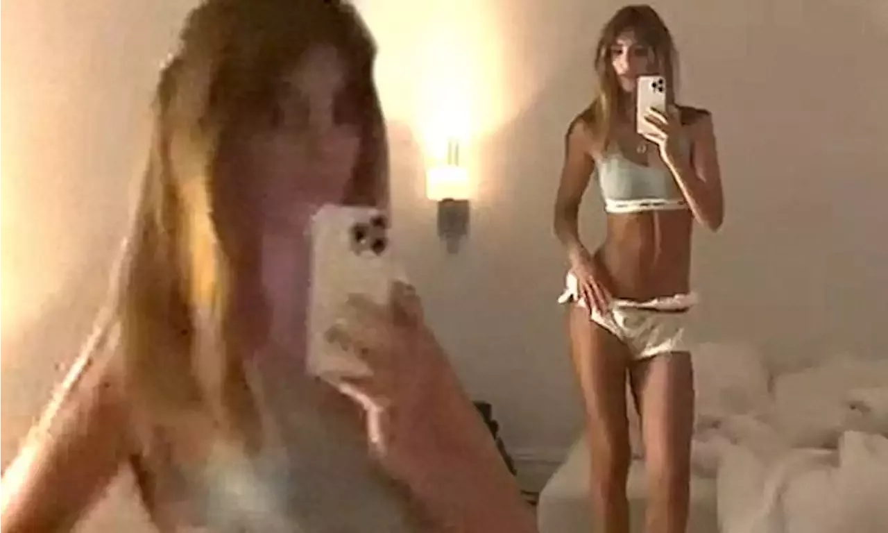 Emily Ratajkowski dances around in tiny shorts and a white bralette