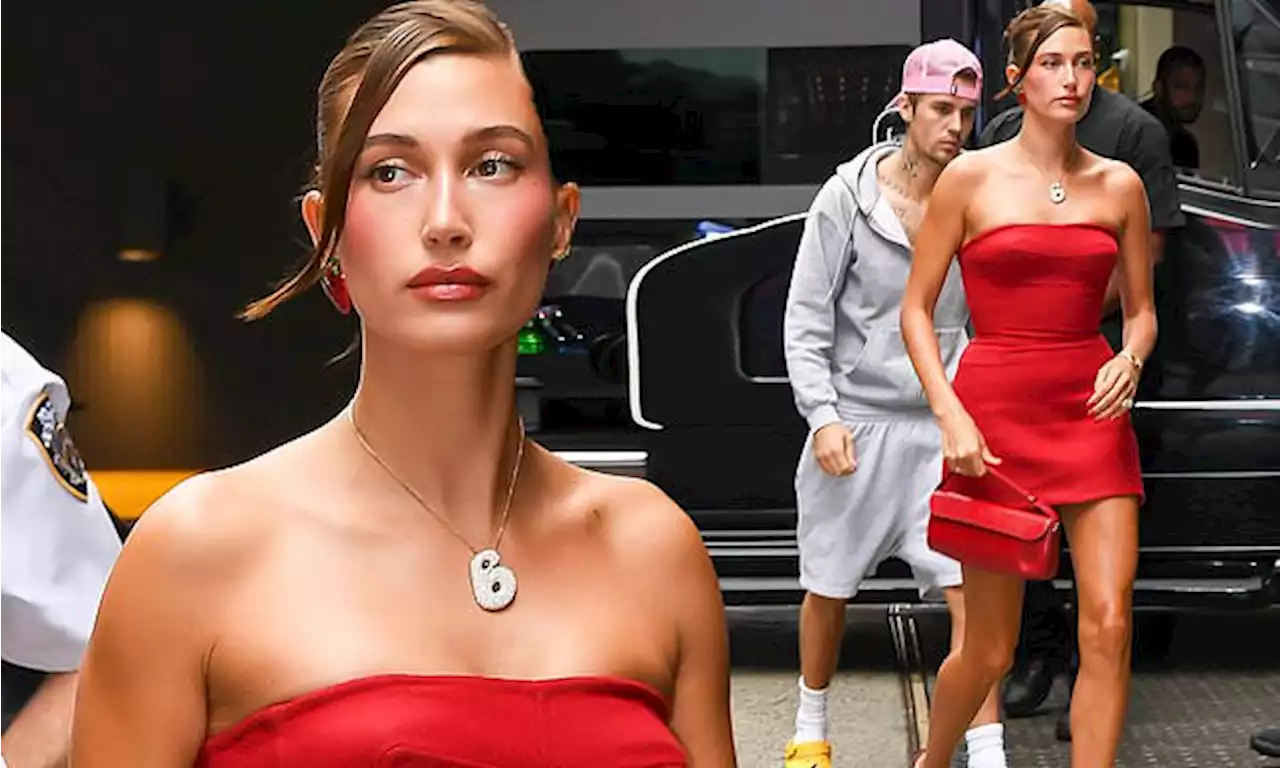 Hailey Bieber models B necklace with Justin Bieber one step behind