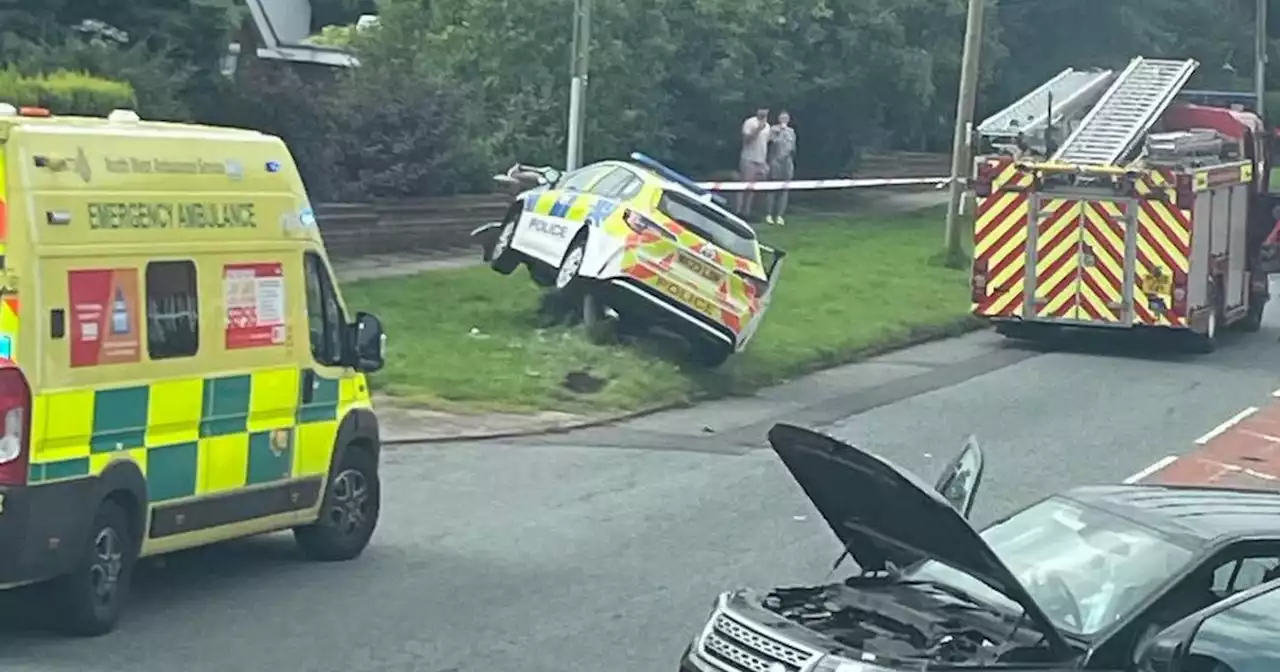 Police officers escape unharmed after GMP car slams into pole