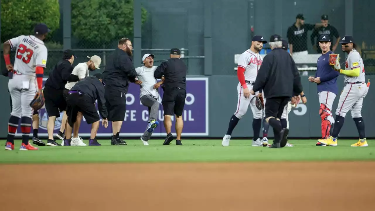 Fans rush field, incident ends with Atlanta Braves star Ronald Acuña Jr. knocked to ground