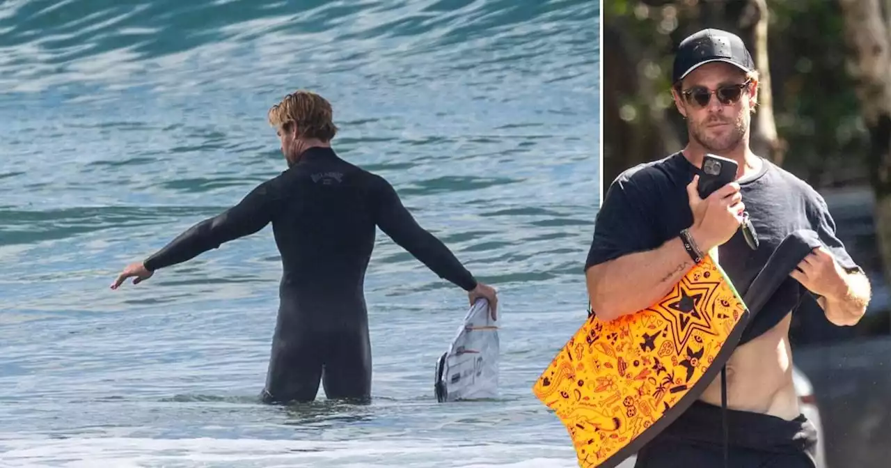 Chris Hemsworth, 40, lifts his shirt to reveal his razor-sharp sculpted V-line