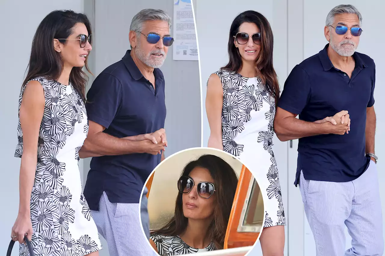 Amal and George Clooney arrive in Venice in matching blue-and-white outfits