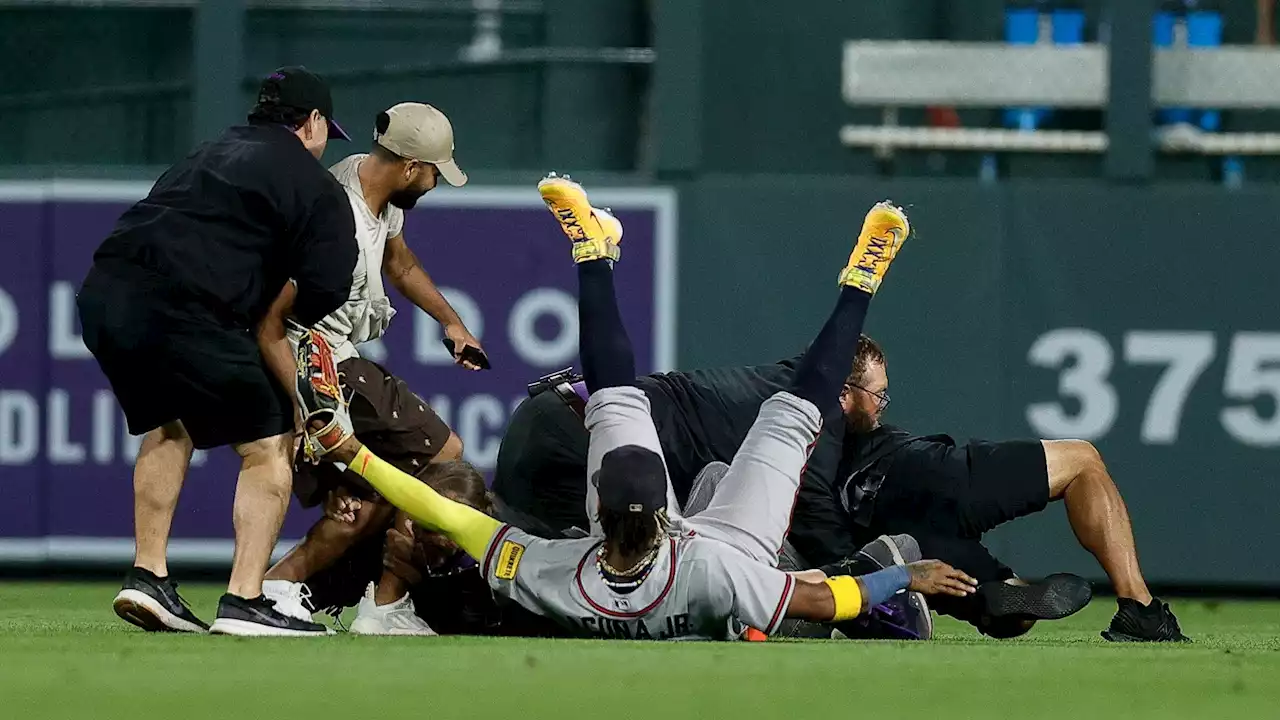 Ronald Acuna Jr. knocked to ground by fans running onto field