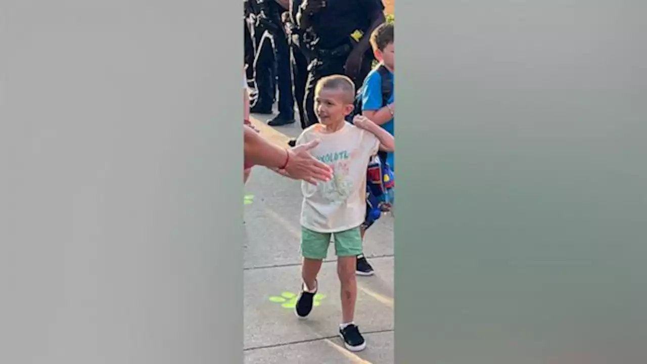 Police line sidewalk to welcome fallen officer's son on 1st day of school