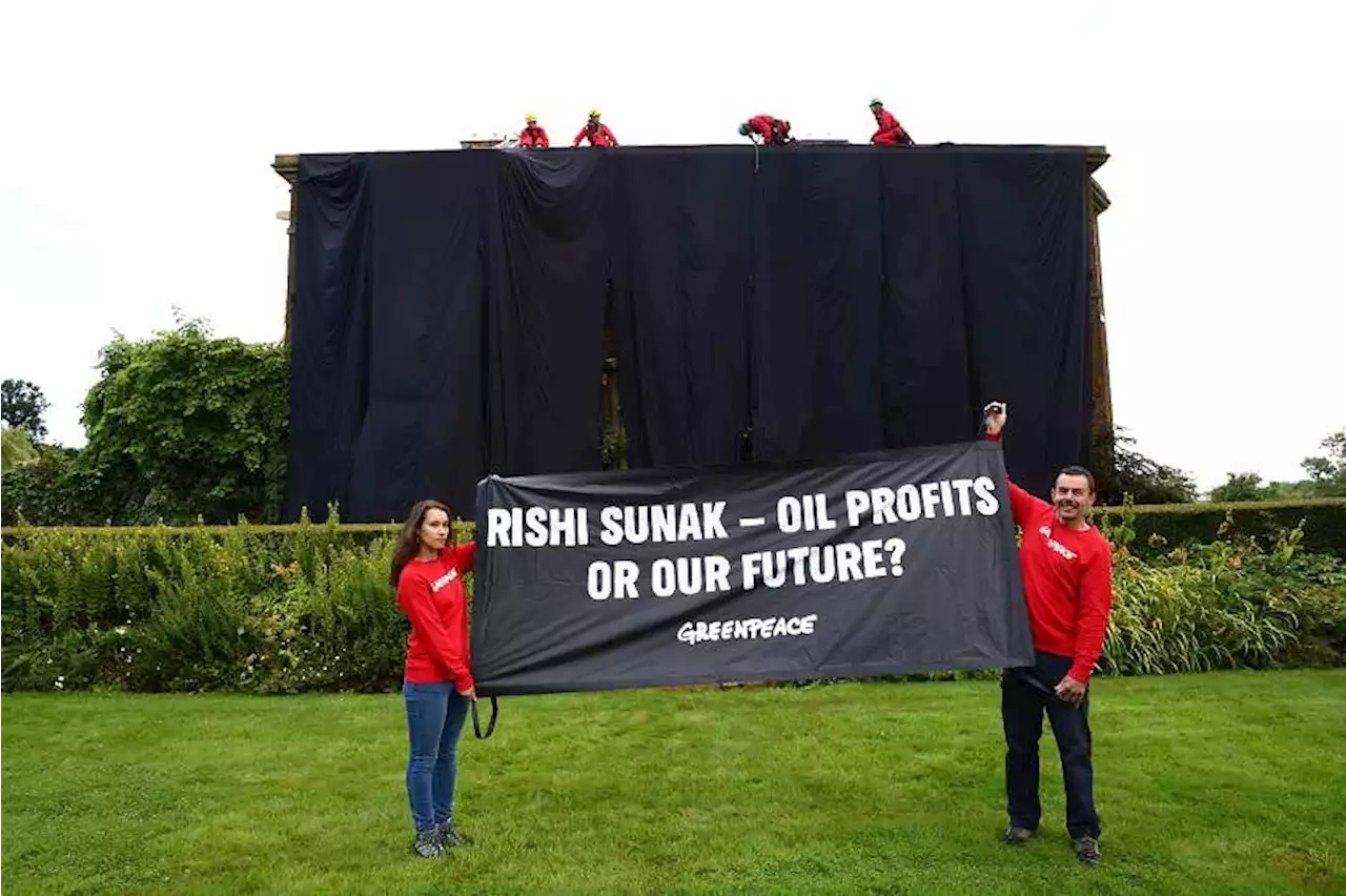 Protesters drape home of British PM Sunak in black fabric over energy policy