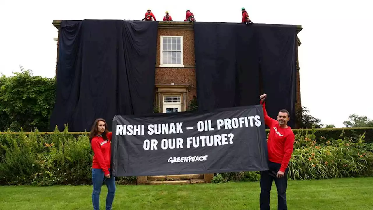 Environment activists drape UK PM Sunak's home in black fabric