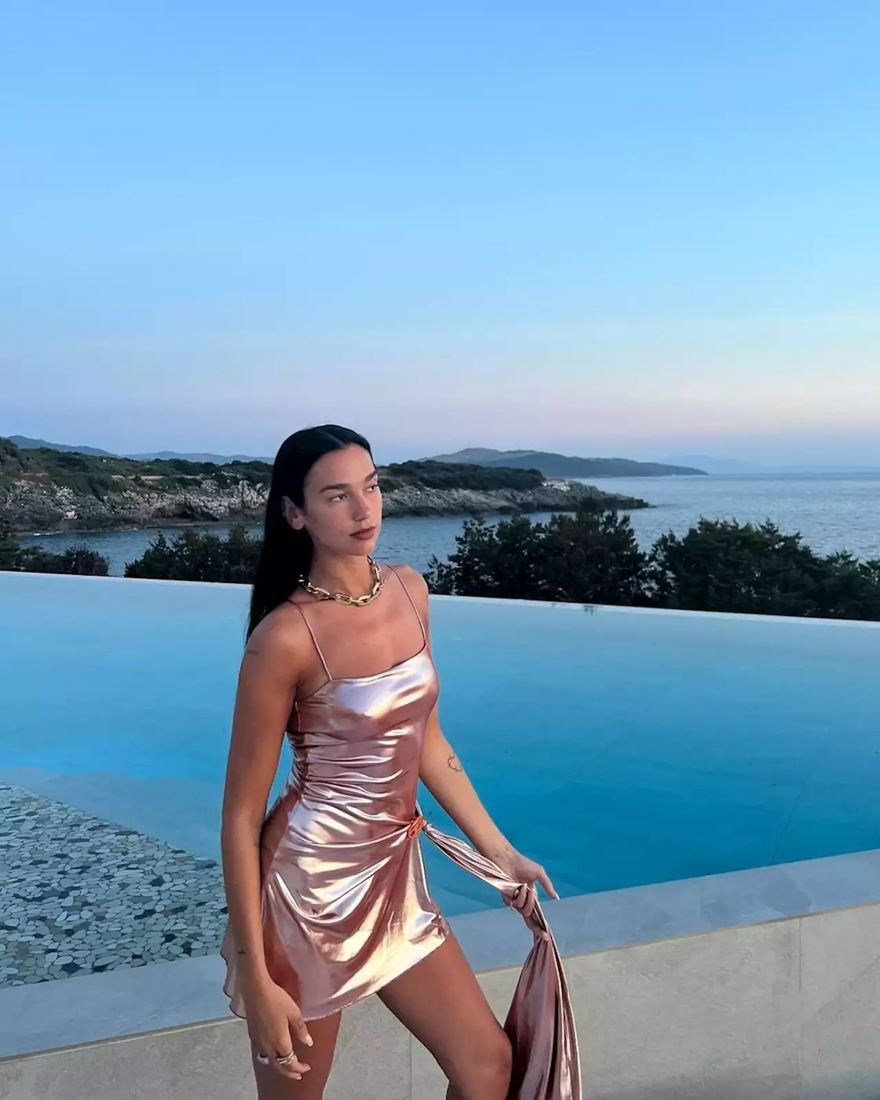 Dua Lipa Channels Her Inner Beach Barbie In a Metallic Mini Dress