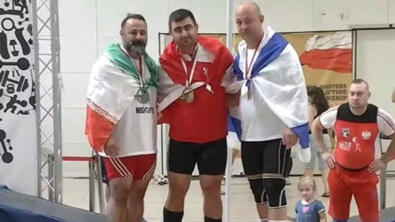 Iran bans weightlifter for life over handshake with Israeli competitor