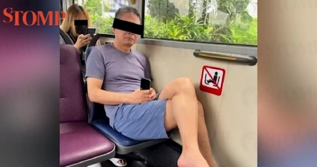 Bus passenger who put his bare feet on seat allegedly assaults another who took photo