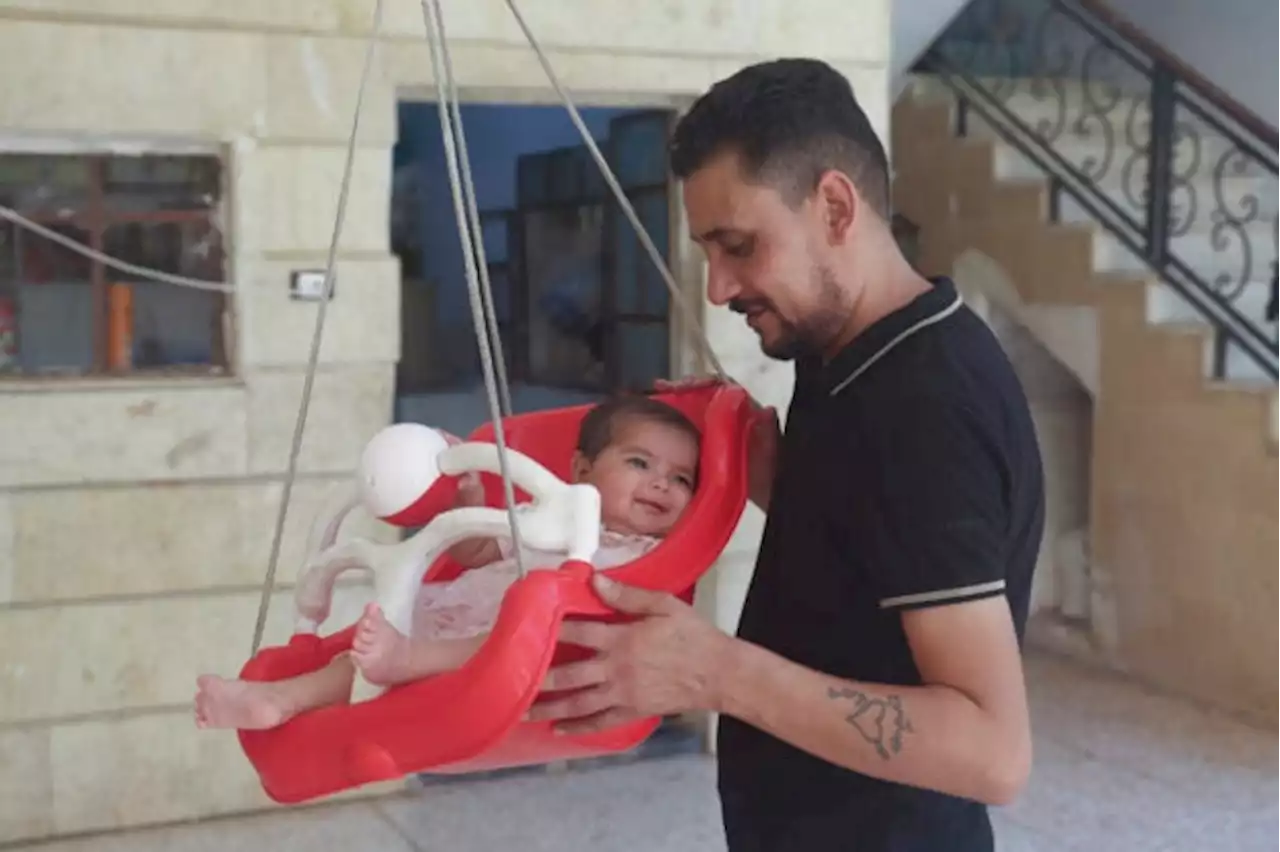 Syrian baby born under earthquake rubble turns 6 months, happily surrounded by her adopted family