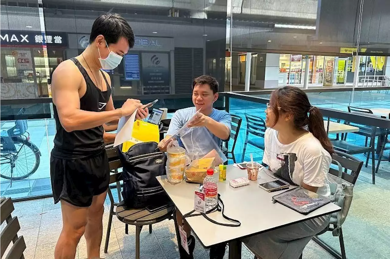 Volunteers in Singapore help collect and deliver postal ballots for the Malaysia state elections