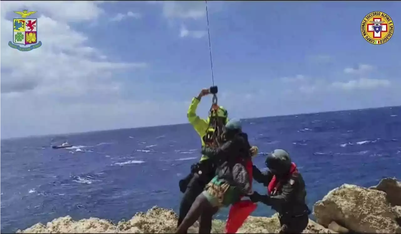 Dozens saved by Italy from migrant shipwrecks; some, clinging to rocks, plucked to safety by copters