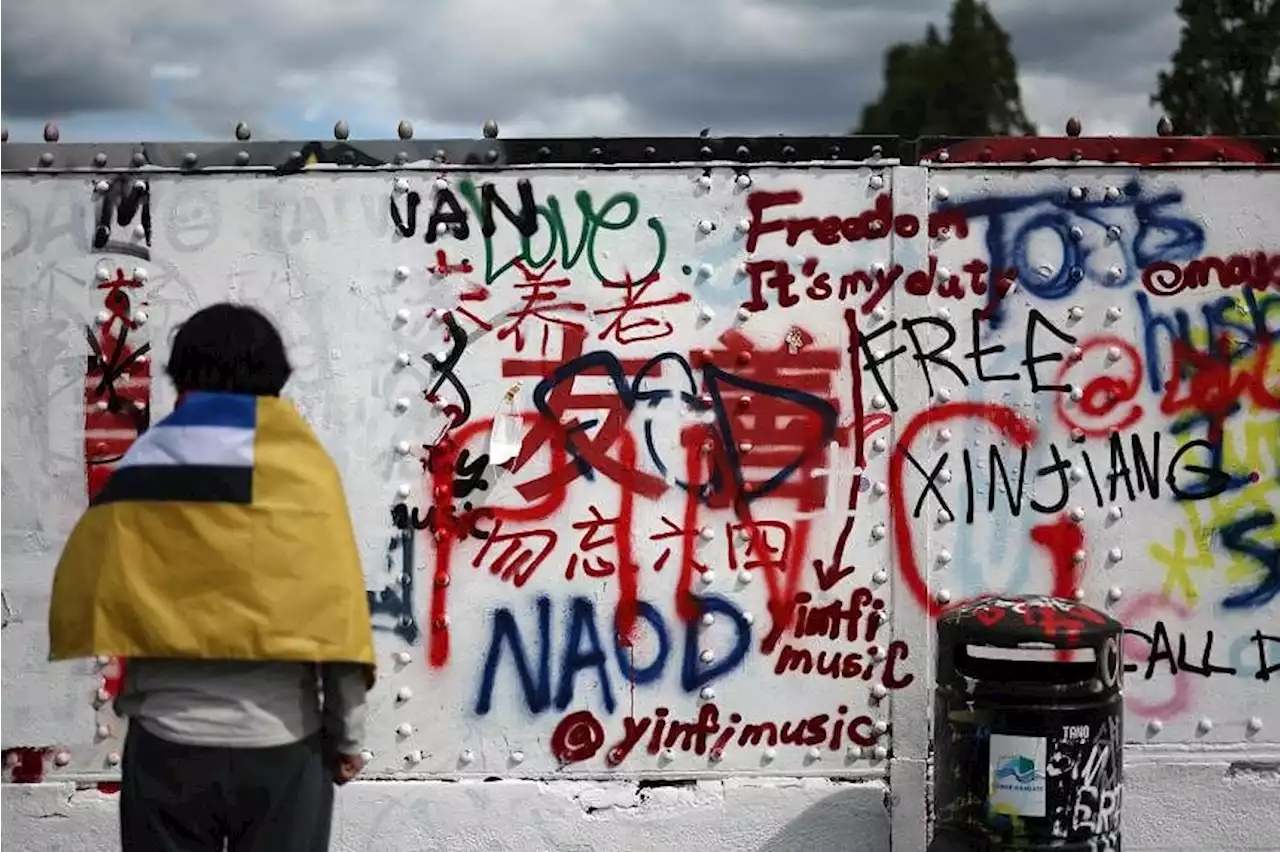 Graffiti battle erupts on London street wall over Chinese politics