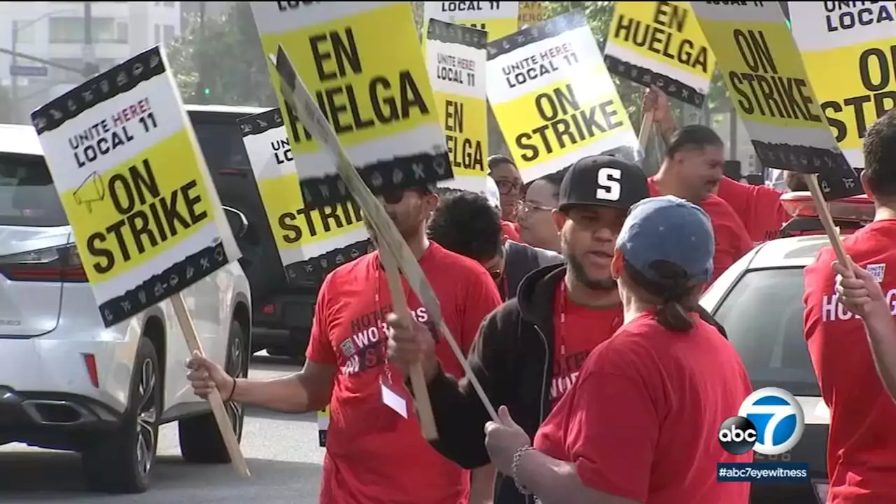 Hundreds of striking hotel workers take to the streets of downtown LA, blocking intersections