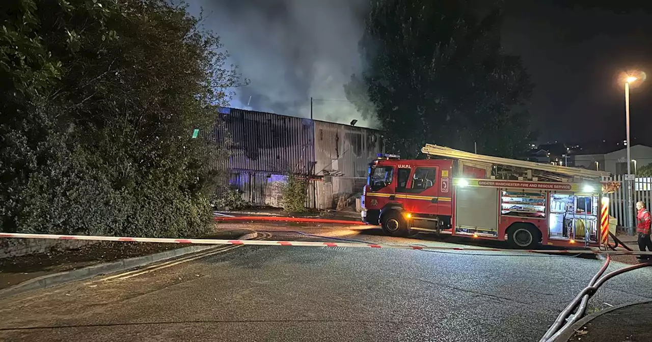 Crews descend on Greater Manchester street amid huge fire