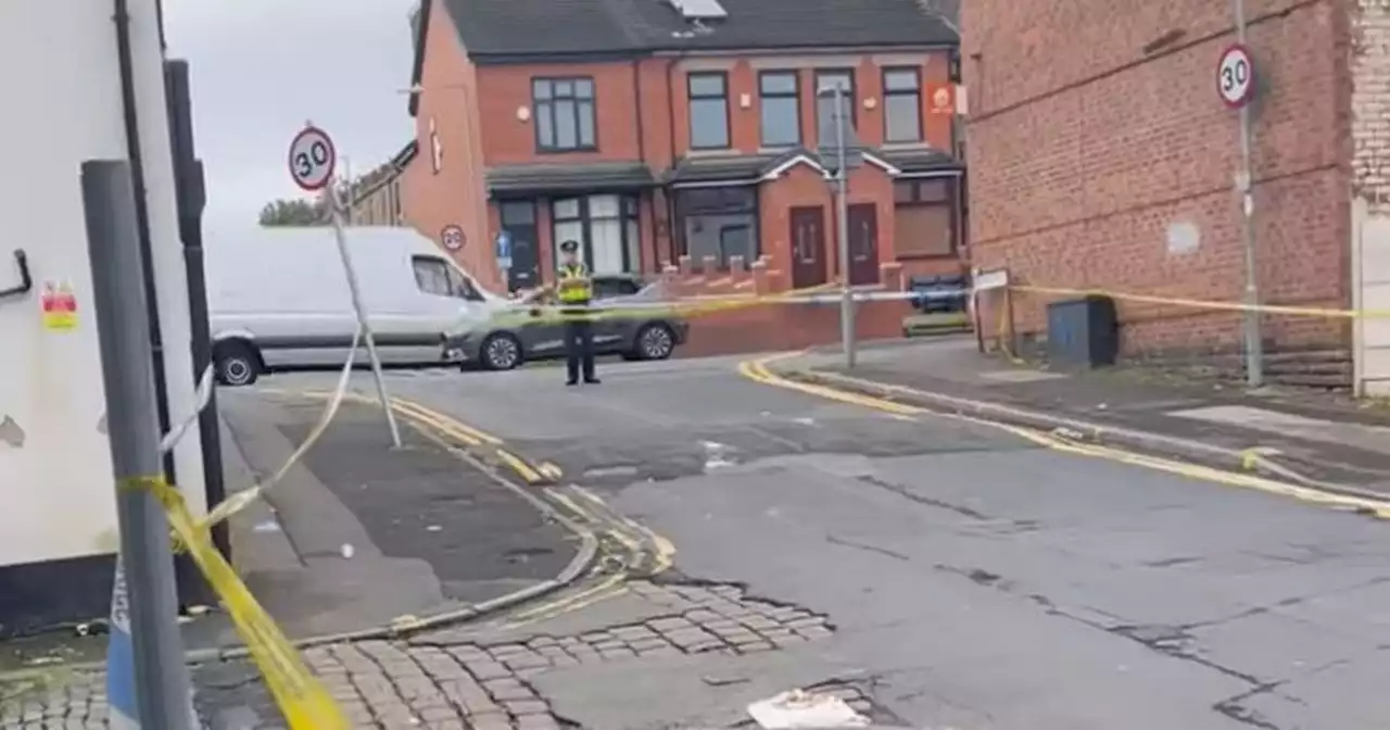 Police tape off Greater Manchester street with huge cordon in place