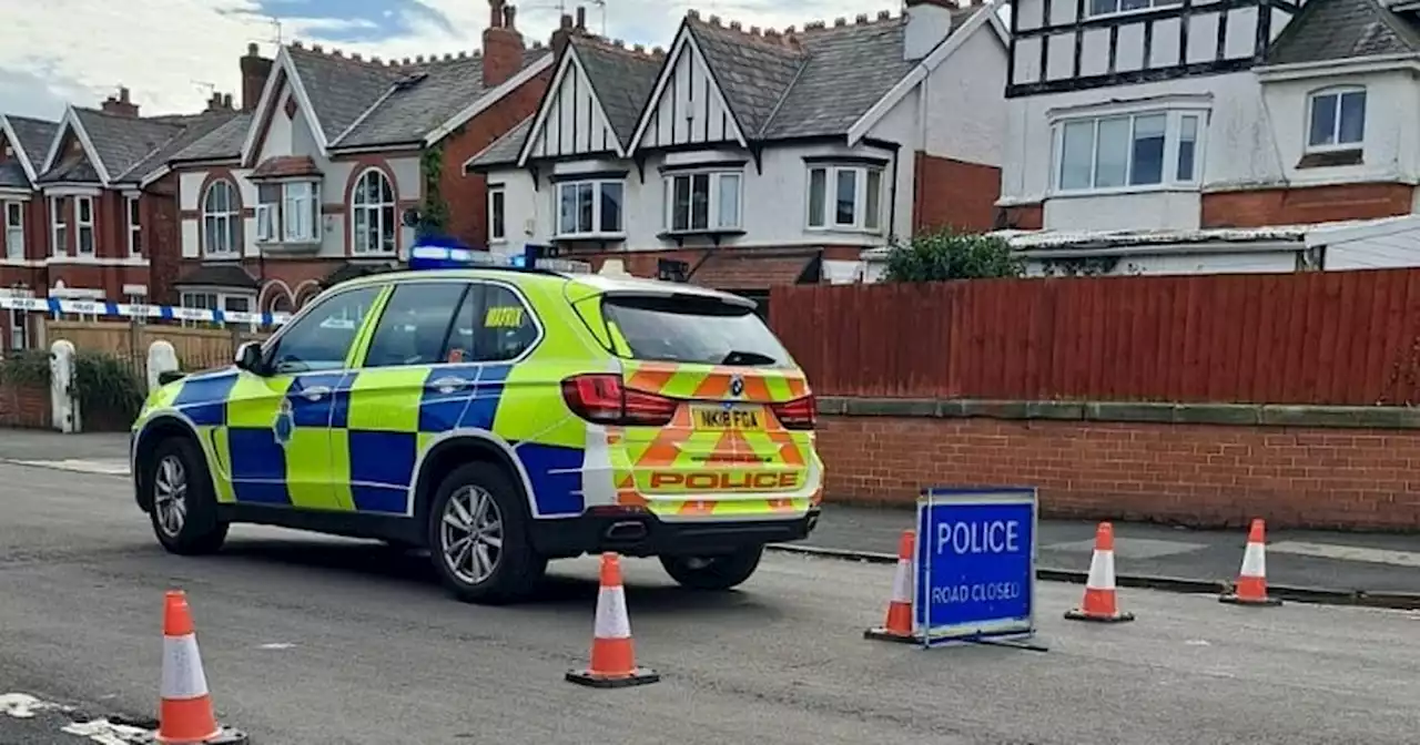 Man seriously injured and road closed after crash outside house