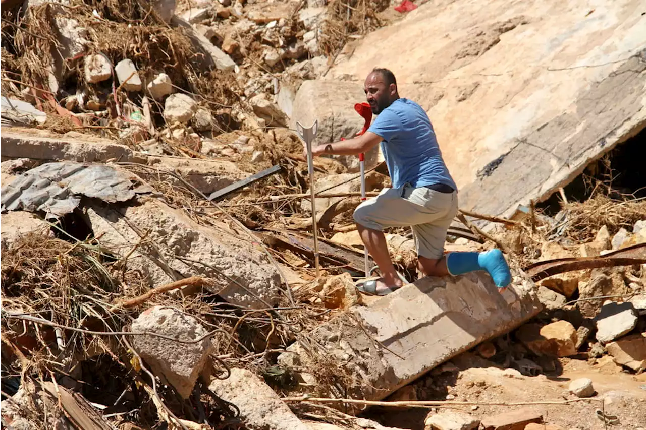 Libyan flood survivors pick through ruins in search of loved ones